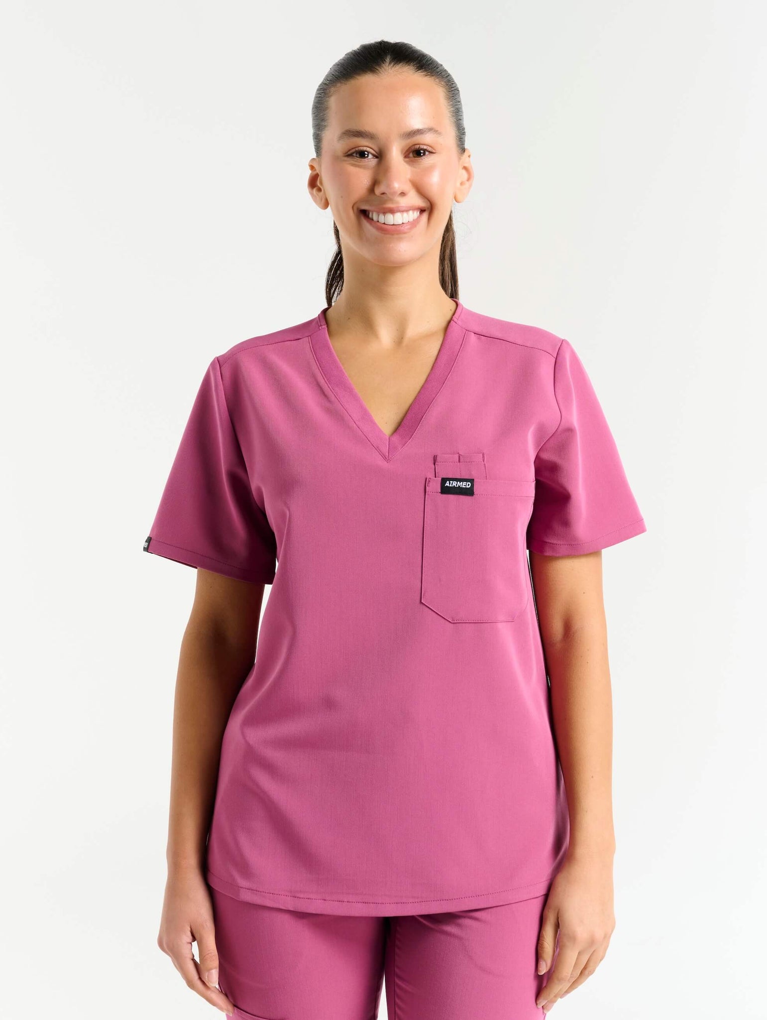 front view of red violet one pocket v neck scrub top